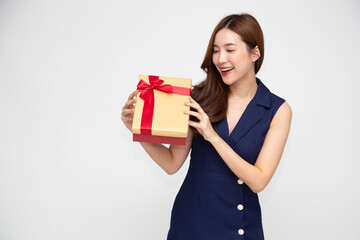 Happy beautiful Asian woman smiling and holding gold gift box isolated on white background....
