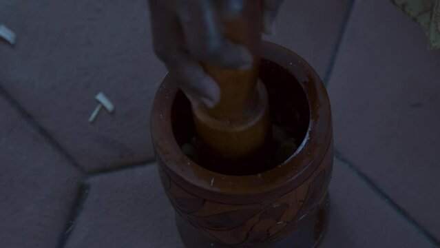 Vegetables being mashed in mortar and pestle