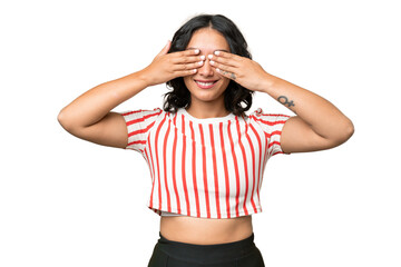 Young Argentinian woman over isolated background covering eyes by hands