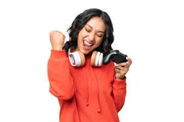 Young Argentinian woman playing with a video game controller over isolated background celebrating a victory