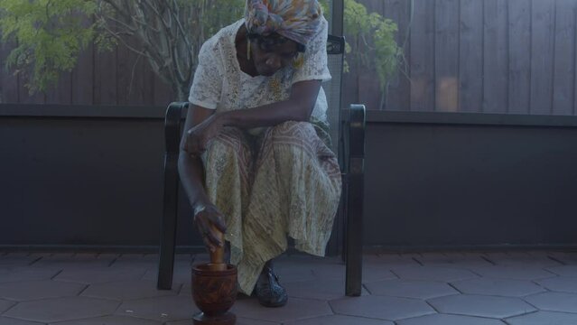 Woman mashing vegetables in mortar and pestle