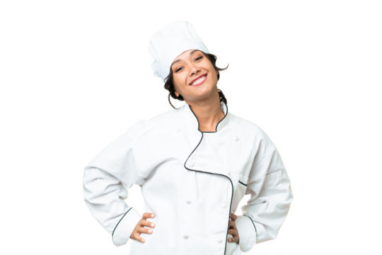 Young chef Argentinian woman over isolated background posing with arms at hip and smiling