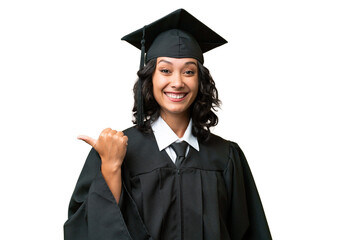 Young university graduate Argentinian woman over isolated background pointing to the side to...
