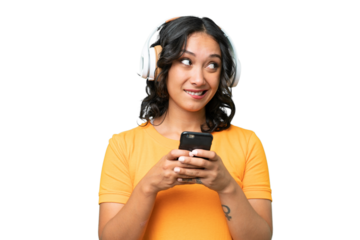 Young caucasian Argentinian woman over isolated background listening music with a mobile and thinking