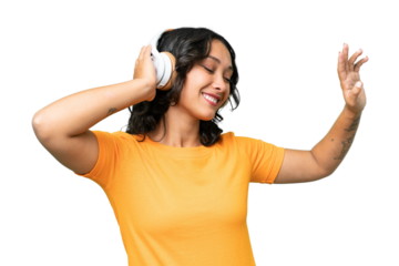 Young caucasian Argentinian woman over isolated background listening music and dancing