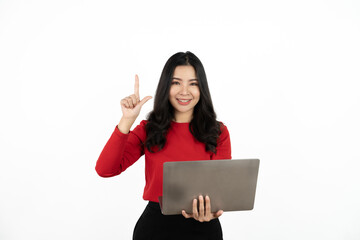 Naklejka premium Happy asian business woman holding laptop computer and looking at the camera over white background.