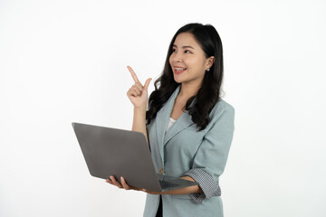 Happy asian business woman holding laptop computer and looking at the camera over white background.