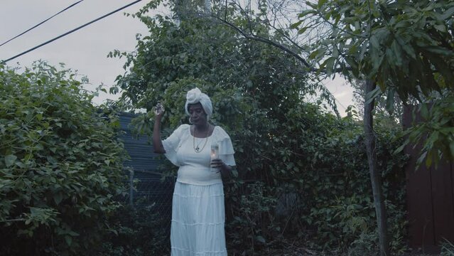 Woman holding candle praying