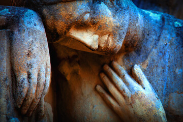 Ancient stone statue of sad and desperate woman on tomb as a symbol of death and the end of human...