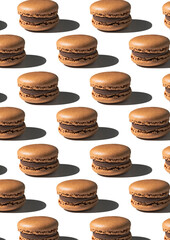 Pattern with chocolate macarons on white background