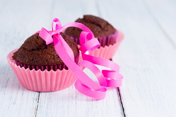 chocolate muffins on white wooden table