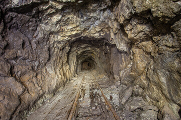 Underground gold mine shaft tunnel drift with rails