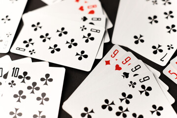 gambling card game. cards tens nines black and red diamonds worms clubs and spades on a dark...