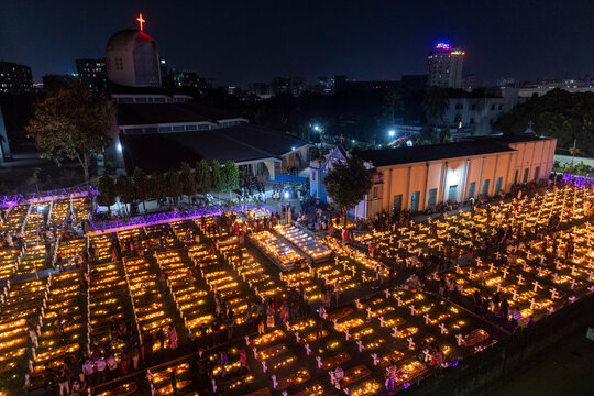 Dhaka, Bangladesh - 02 November 2018: Aerial view of a people praying on a graveyard in a cemetery in Dhaka, Bangladesh.