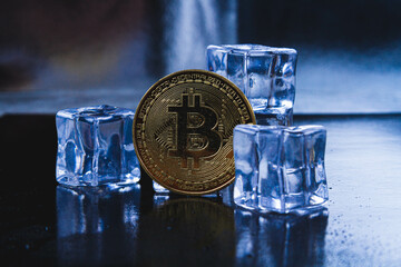 Ice and bitcoin coin. Freezing of cryptocurrency accounts. Frozen bitcoin coin.
