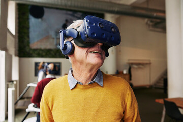 Senior man wearing a vr headset smiling