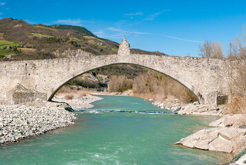 The old medieval bridge called Ponte Gobbo over the river Trebbia in the small town of Bobbio, in northern Italy