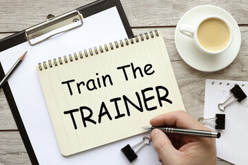 a man writes text on a page, TRAIN THE TRAINER