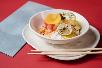 poke bowl salad with fish lemon and vegetables. traditional Hawaiian raw fish salad.