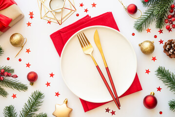 Christmas table setting with plate, cutlery and christmas decorations on white background....