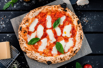Pizza Margherita with mozzarella, tomato sauce, spinach on a thick dough.
