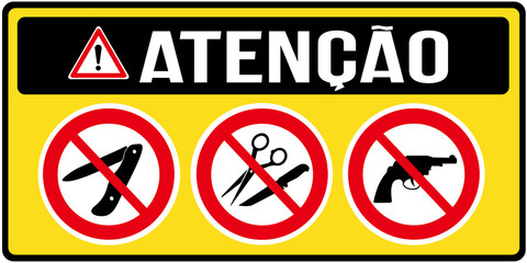 A sign  that says in Portuguese language : ATTENTION no  knife, no switchblade, no sharp objects, no scissor, or no revolver. Prohibition sign