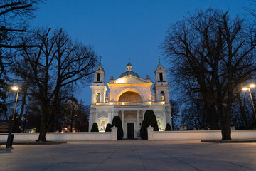 front view of the beautiful church of St. Anne in Wilanow Warsaw Poland with two towers the photo was taken in evening against a blue sky