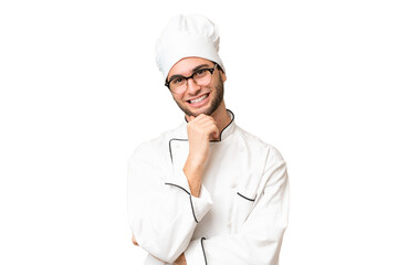 Young handsome chef man over isolated background with glasses and smiling