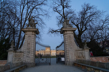 Fototapeta na wymiar a gate with an open gate overlooking an Royal Wilanow Palace located in the Wilanów district, Warsaw an early spring evening
