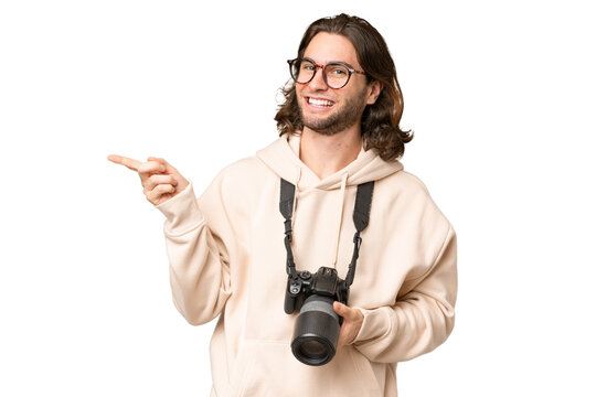 Young photographer man over isolated background pointing finger to the side