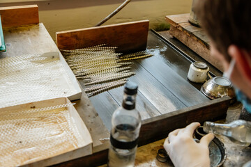 Ponikla, Czech Republic, 31 December 2021: Glass bead vintage ornaments and figurines hand-manufacturing, traditional production of Christmas and New Year decorations, decorative hand painted