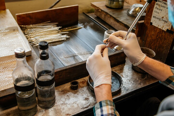 Ponikla, Czech Republic, 31 December 2021: Glass bead vintage ornaments and figurines hand-manufacturing, traditional production of Christmas and New Year decorations, decorative hand painted