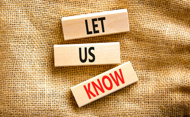 Let us know symbol. Concept words Let us know on wooden blocks on a beautiful canvas table canvas background. Business and let us know concept. Copy space.