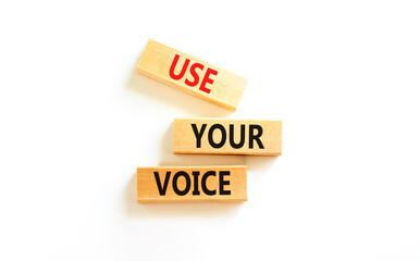 Use your voice symbol. Concept words Use your voice on wooden blocks on a beautiful white table white background. Business and use your voice concept. Copy space.