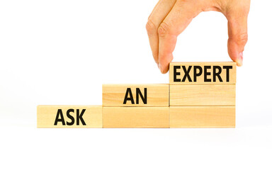 Ask an expert symbol. Concept words Ask an expert on wooden blocks on a beautiful white table white background. Businessman hand. Business and ask an expert concept. Copy space.