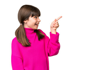 Little caucasian girl over isolated background pointing away