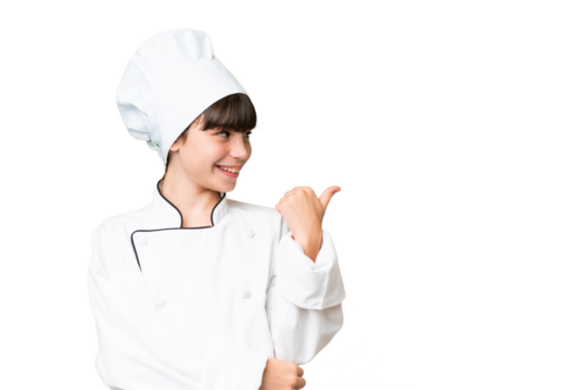 Little caucasian chef girl over isolated background pointing to the side to present a product