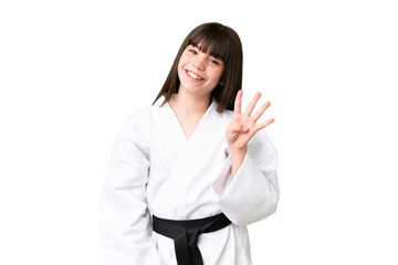 Little Caucasian girl doing karate over isolated background happy and counting four with fingers
