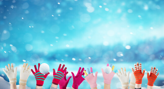 children hands with winter gloves and snowballs, christmas background