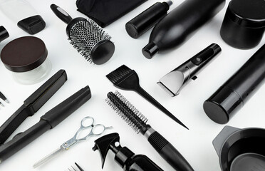 Set hairdresser's accessories on white background. Composition with scissors, , spray, shampoo, brush, curling iron, comb, hair clipper, other hairdresser's accessories on white background.