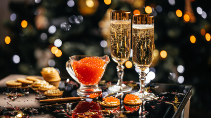 Elegant glass of champagne with red caviar on golden spoon and glass container of caviar, Gourmet food close up, appetizer, selective focus, place for text © Надія Коваль