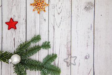 Christmas decoration as a greeting card with pine branch and star with space for text, vintage wood background in studio