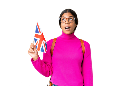 Young African American woman holding an United Kingdom flag over isolated chroma key background looking up and with surprised expression
