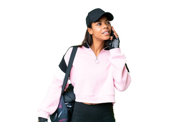 Young sport African American woman with sport bag over isolated chroma key background keeping a conversation with the mobile phone