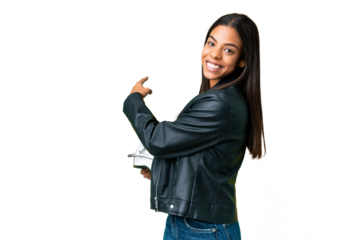 Young African American woman with a motorcycle helmet over isolated chroma key background pointing back