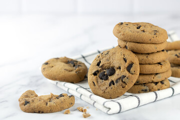 A stack of homemade chocolate chip cookies on a white background. National cookie day poster. Food background.