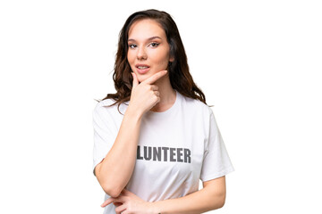 Young volunteer caucasian woman over isolated background thinking
