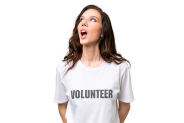 Young volunteer caucasian woman over isolated background looking up and with surprised expression