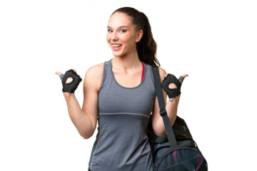 Young sport woman with sport bag over isolated background with thumbs up gesture and smiling