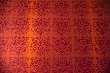 part of the decor and the material from which it is made;
old red wallpaper with the same patterns
